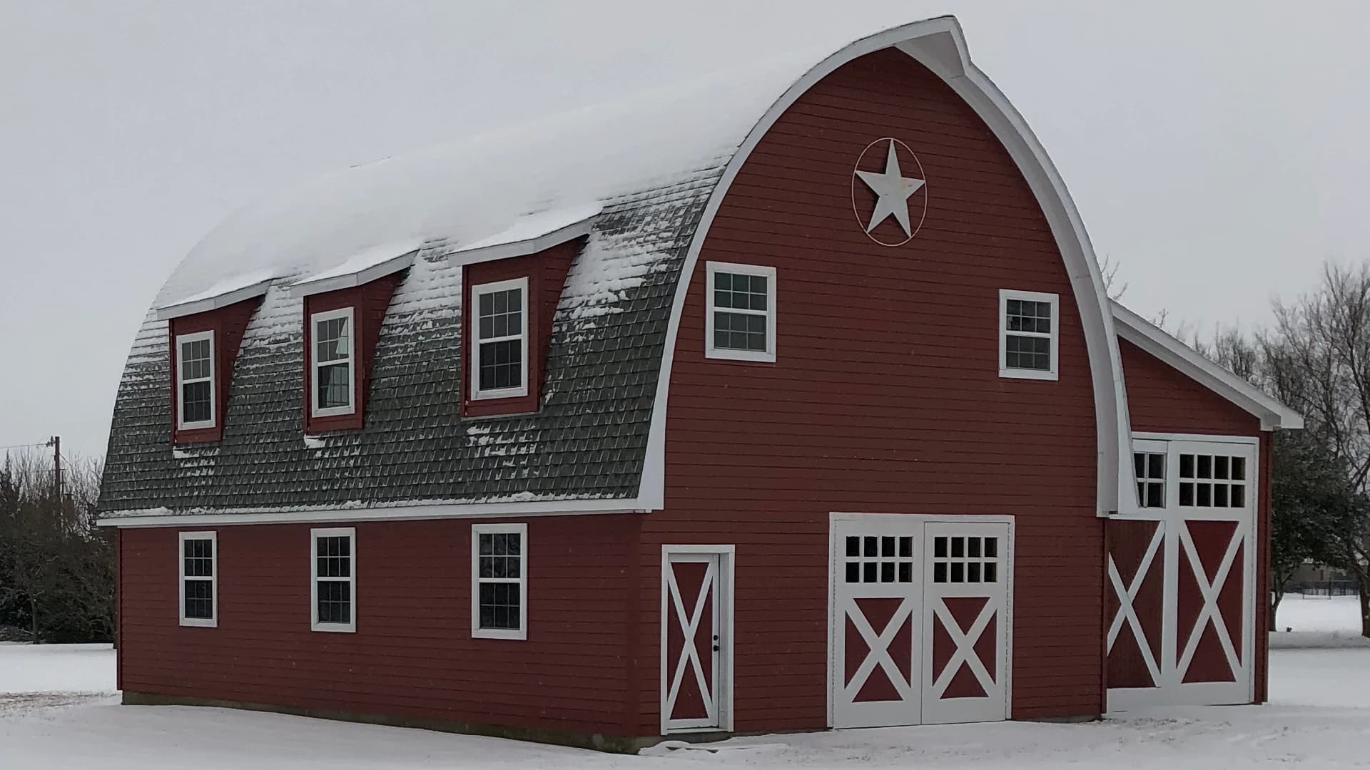 Image of a red barn in the snow.