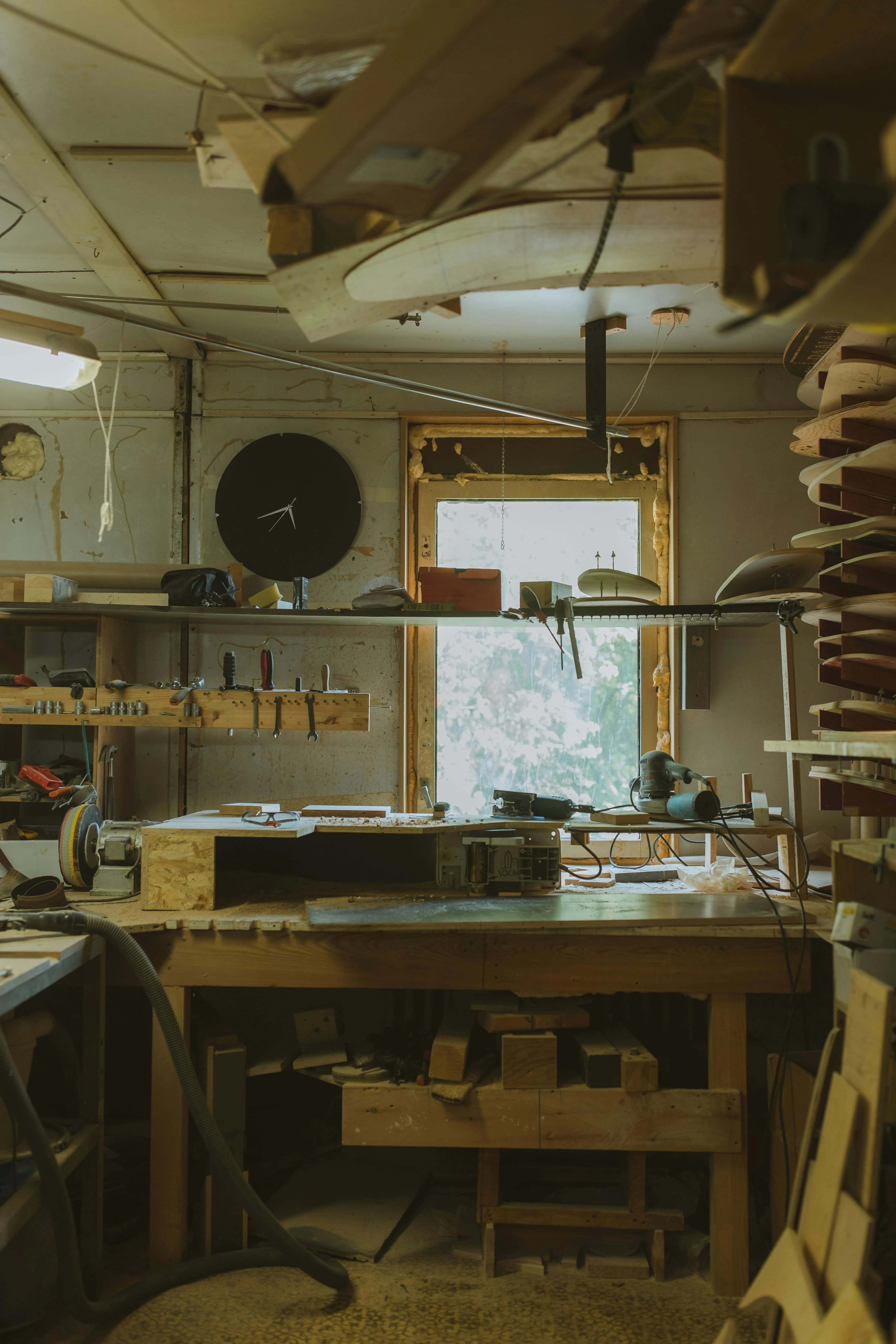 Image of a home woodshop with a wooden workbench and tools.