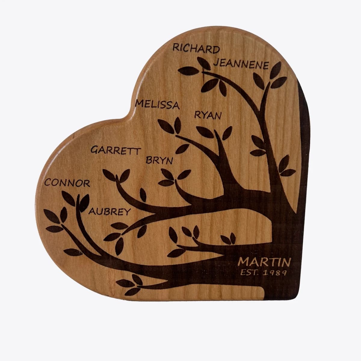 Wooden heart with a a family tree diagram engraved on it.